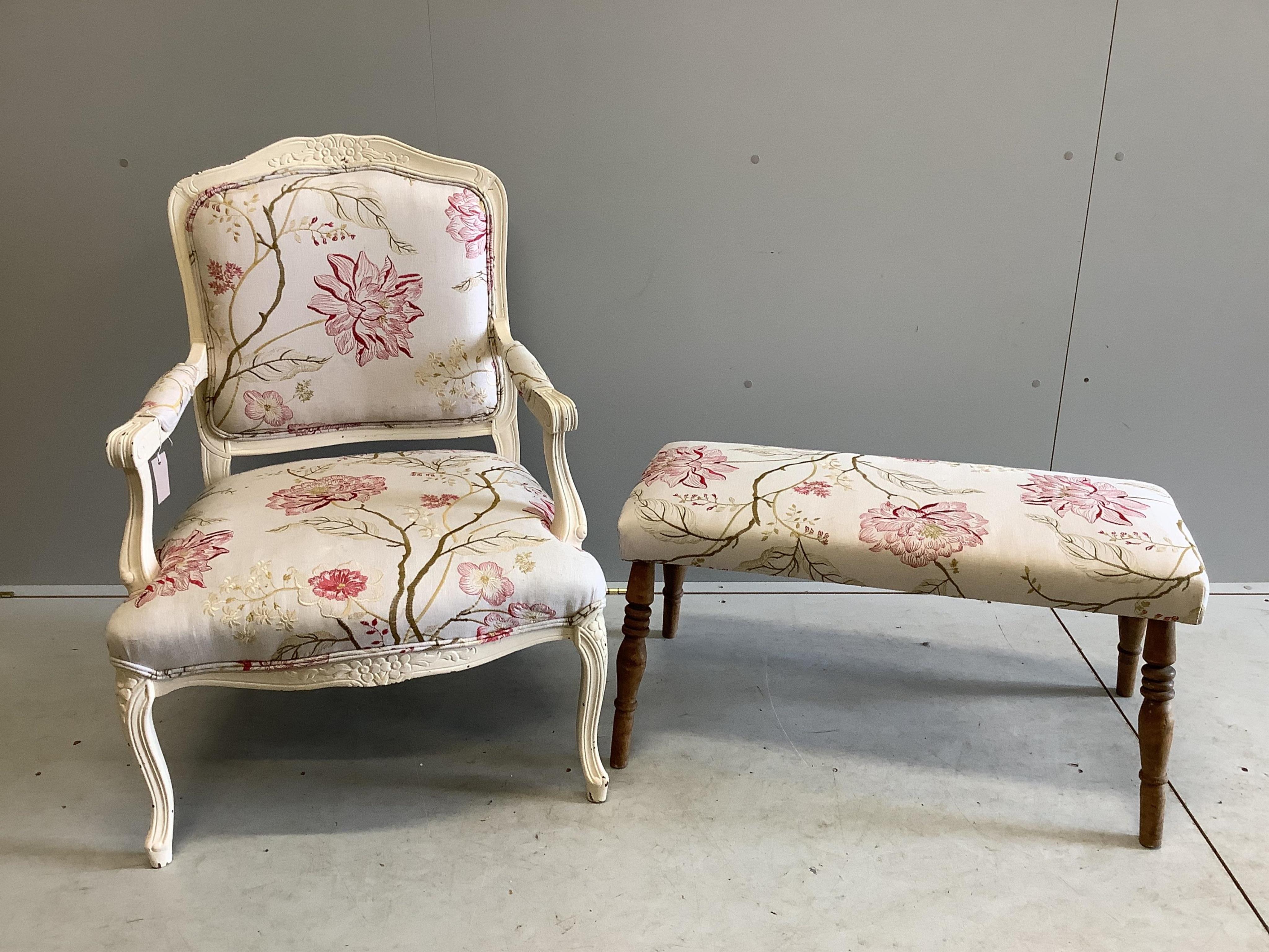 A Louis XVI style elbow chair and associated footstool upholstered in Voyage? fabric, chair width 65cm, depth 56cm, height 94cm. Condition - fair to good